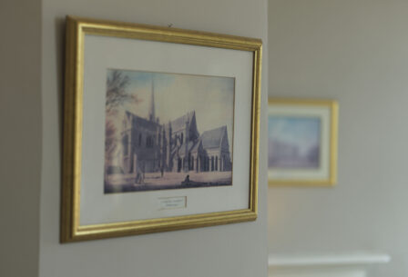 Elegant framed painting of a cathedral hangs on a cosy guesthouse wall.