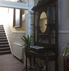 Charming guesthouse hallway with vintage décor and a welcoming atmosphere.
