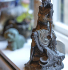 Elegant statue on a windowsill in Harveys Guesthouse, exuding warmth and artistic charm.